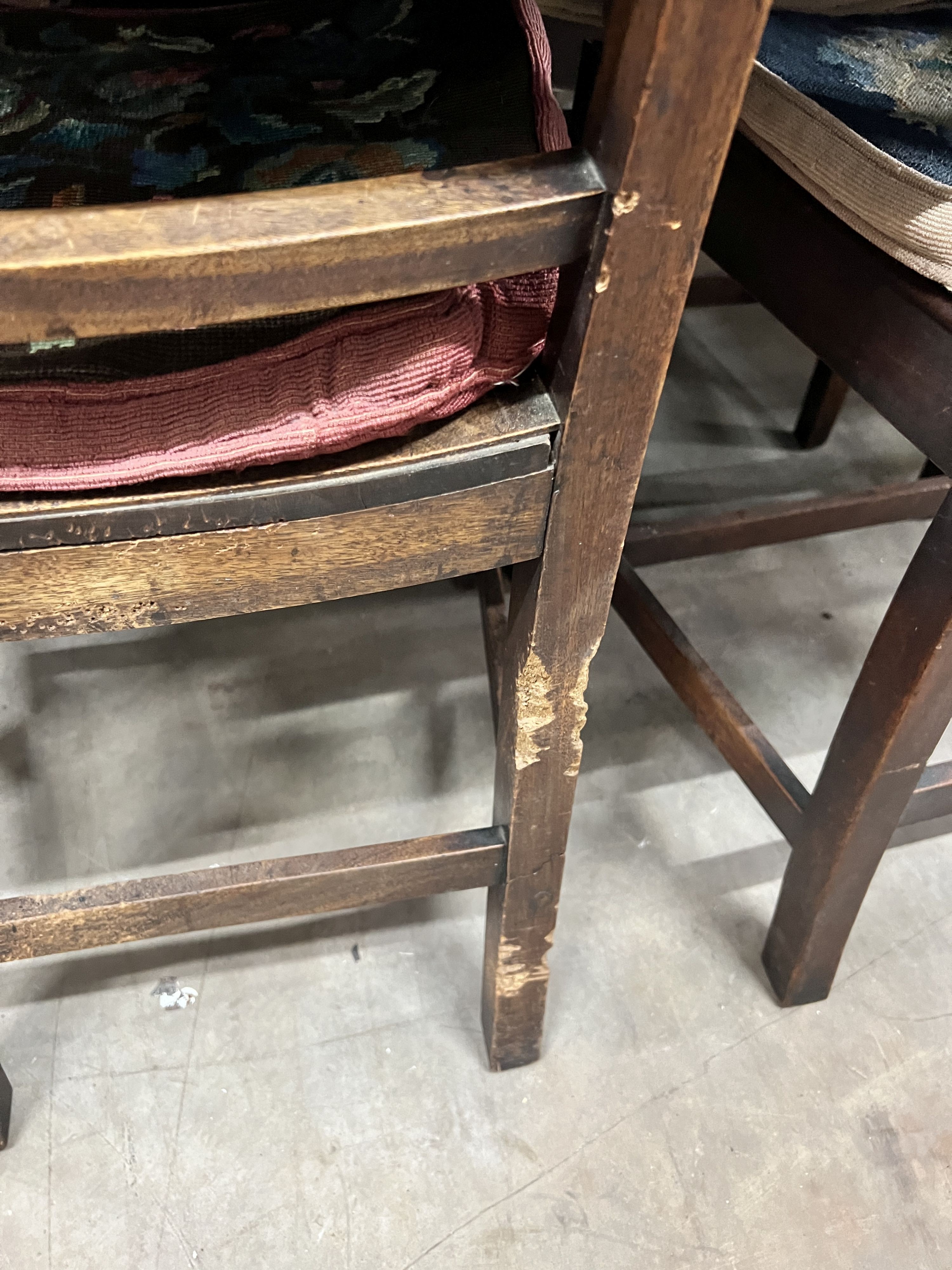 A set of six (4 + 2) Georgian mahogany dining chairs, with solid dished seats, on square tapering legs, gros-panel needlework cushions